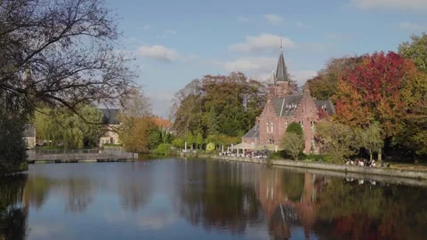 Bruges castle next to a lake in Belgium with people enjoying the sun Stock-Footage 329052592