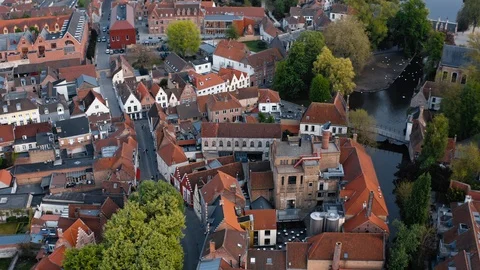 Bruges: flight over red roofs of houses in the center of city Stock Footage 124305146