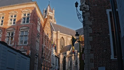 Bruges, St. Salvator's Cathedral with flags on houses Stock Footage 124395638