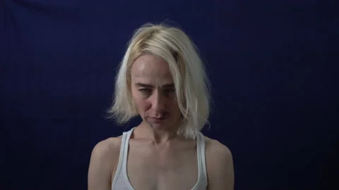 The bruised blonde looks directly at the camera. Violence against women. Sexual 스톡 동영상 130565802