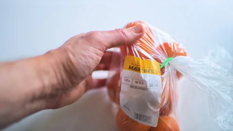Bruised overripe orange fruit in plastic bag on discount reduced price 库存影片 330176902