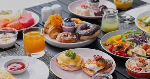 Brunch spread sitting on outdoor dining table Stockbeeldmateriaal 334408490