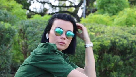 The brunette adjusting her locks while swaying gently to the music  Stock Footage 265617689