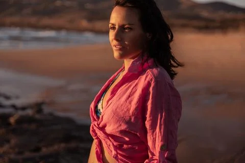 Brunette on beach at sunset Stock Photos