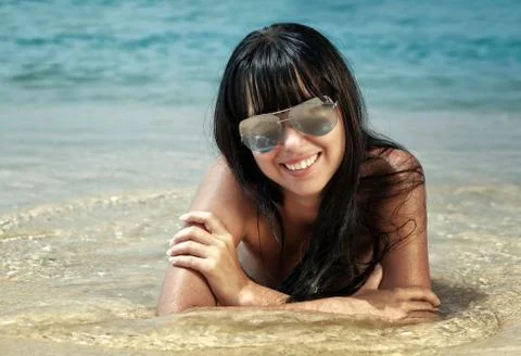 Brunette beautiful model posing on a beach Foto stock