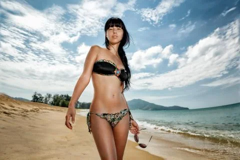 Brunette beautiful model posing on a beach Stock Photos