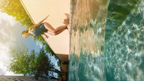 Brunette diving in the swimming pool in slow motion Stock Footage 99380160