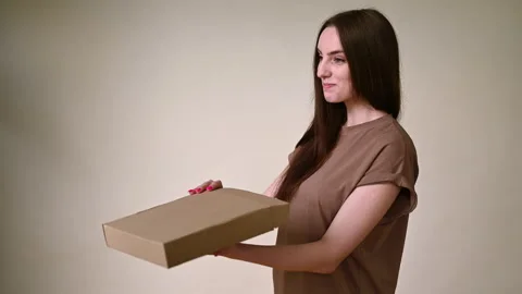 The brunette does not successfully open the box close-up with a smile on her  Stock Footage 196858136