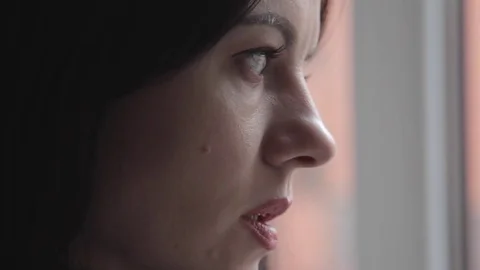 Brunette drinking coffee and looking out of the window Video stock 74598839
