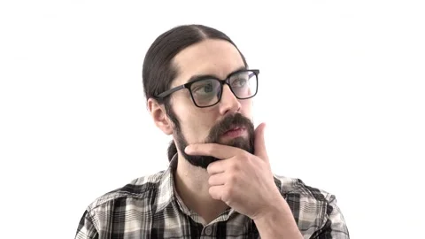 Brunette eastern man with beard looks away thoughtfully. Man scratching his bear Stock Footage 132714340