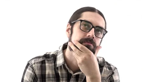 Brunette eastern man with beard looks away thoughtfully / Man scratching his bea Stock Footage 132714401