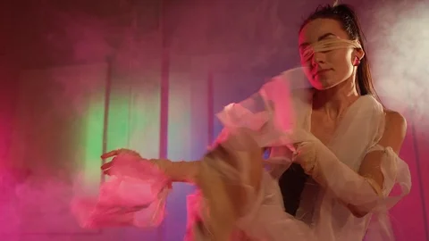 Brunette female dancer is dancing alone in room with smoke Stock-Footage 100830637