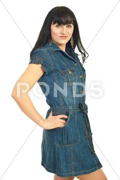 Brunette female in denim dress Stock Photos