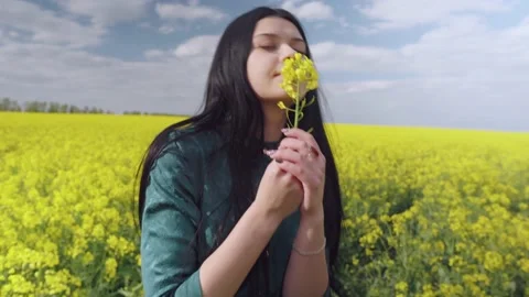 A brunette with a flower poses for the camera. Stock Footage 131549461