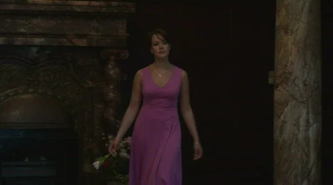 Brunette Girl Walks On The Hall With A Flower In Hand Stock Footage