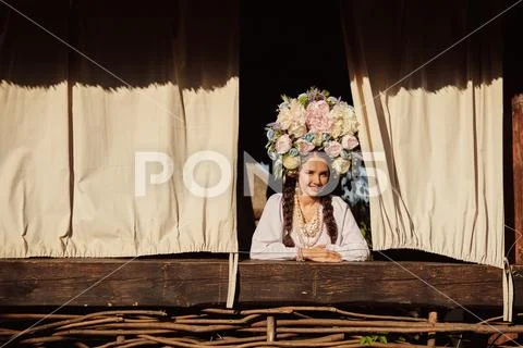 Brunette girl in a white ukrainian authentic national costume and a wreath of Stock Photos