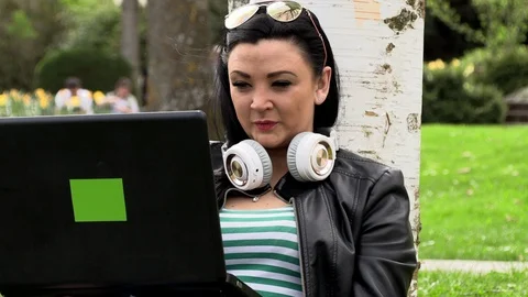 Brunette on the grass with a computer Stock-Footage 107017222