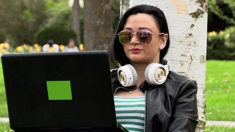 Brunette on the grass with a computer Stock Footage 107034795