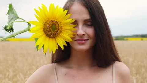 Brunette hides her face behind sunflower. Stock Footage 286295808