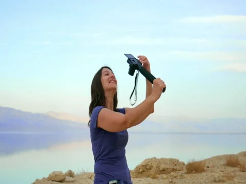 Brunette longhair woman takes selfie in mountains Stock Footage