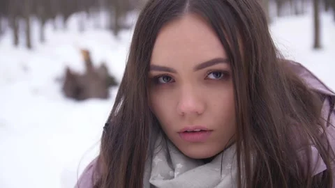 The Brunette is Looking at the Camera. Winter. Close-up Stock Footage 163466774