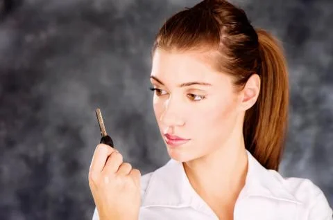 Brunette looking at a key Foto stock