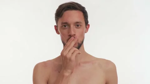 Brunette man with beard, smiles, makes heart hands gesture on white background Stock Footage 147610147