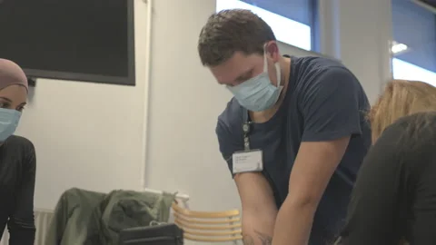 A Brunette Man Thrusting On An Up And Down Motion As He Performs CPR Stock Footage 154951740