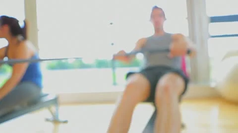 Brunette man working out on row machine Stock Footage