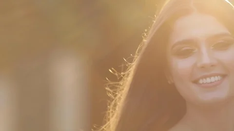 Brunette model with good make up standing in rays of sun. Video stock 105883502