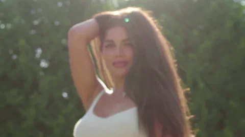 The brunette model plays with the camera and adjusts her hair Stock Footage 157425754