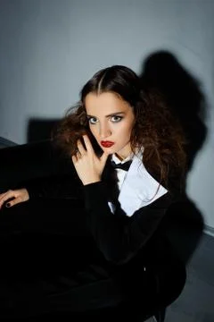Brunette model posing on couch in the studio Stock Photos