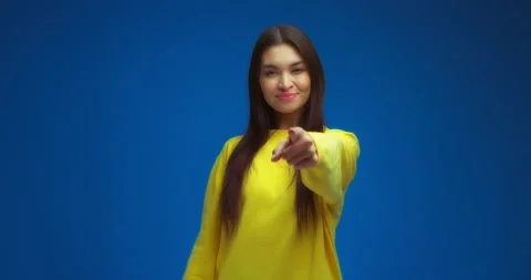 Brunette points her index finger at the camera, shows a handset gesture Stock Footage 195935475