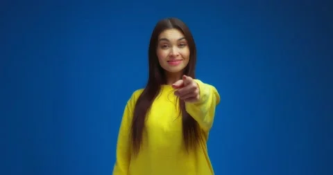 Brunette points her index finger at the camera, shows a handset gesture Stock Footage 195935514