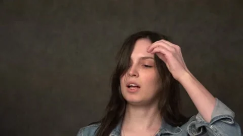 Brunette preparing for make-up singing a song. Stock Footage 64379923