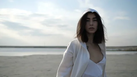 Brunette is puting on her hood Stock Footage 91560824