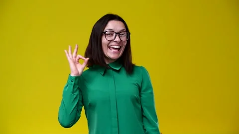 Brunette shows that everything is ok Stock Footage 164497392