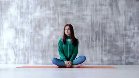 Brunette sitting on the floor and posing Stock Footage 104000913