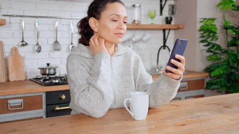 Brunette sitting at the table using mobile Video stock 157161005