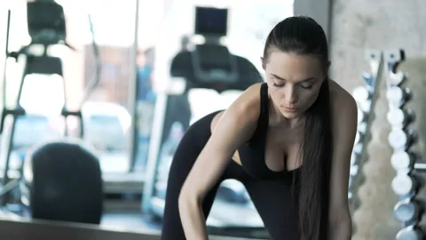 Brunette with slender physique doing exercises using dumbbells. One real person Video stock 199490767