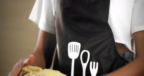 Brunette is standing in the kitchen and kneading baking dough with her hands. Stock Footage 181382441