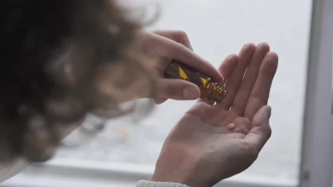 Brunette takes medications without. Dose of three tablets falls from glass v Stock Footage 157452509