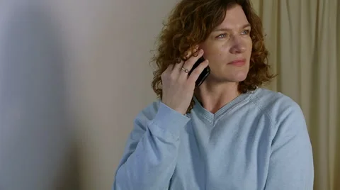 Brunette talks on smartphone Video stock 45621526