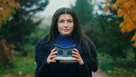 Brunette testing latest augment reality producing equipement VR headset using Stock Footage 81049350