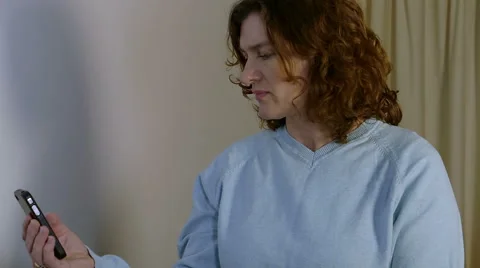 Brunette uses smartphone Video stock 45621553