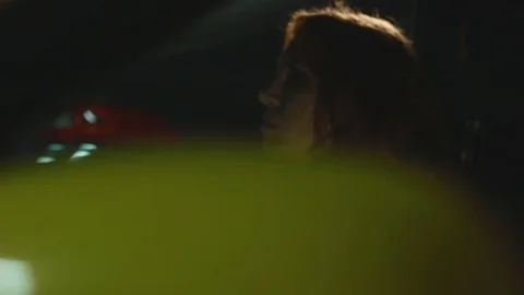 Brunette wait calm with hand on the steering wheel hiding face in shadow in car Stock Footage 70224098