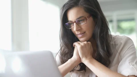 Brunette woman looking at her laptop Stock Footage