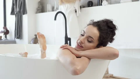 young woman relaxing and takes bubble bath in bathtub with foam, People  Stock Footage ft. woman & bath - Envato Elements