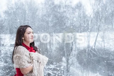 Brunette woman under snowfall Stock Photos