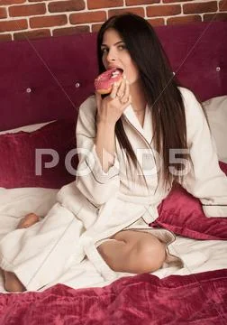 Brunette woman in white bathrobe Stock Photos